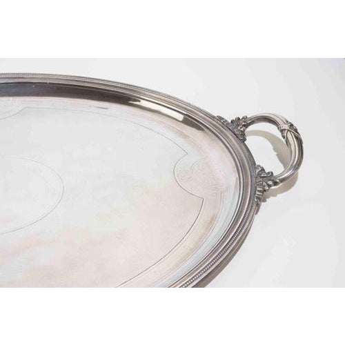Elegant oversized oval serving tray crafted in silver plate by Christofle, featuring refined neoclassical styling with...