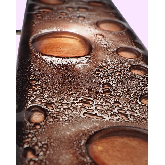 A massive, striking piece of functional art. This brutalist wall hanger combines raw, heavy cast iron with the delicate,...