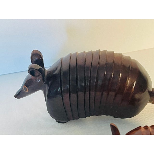 Skillfully carved tropical wood two armadillo figurines.