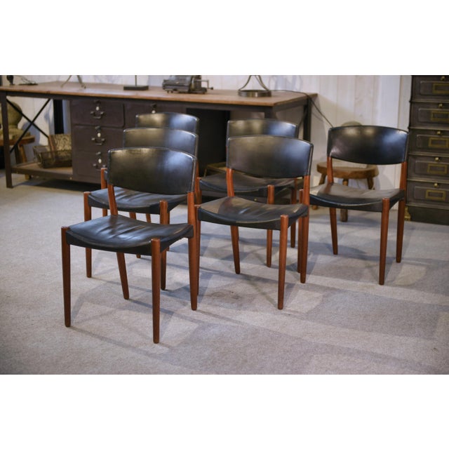 An elegant set of six Danish chairs with a clean, ergonomic design. They feature a solid frame with gentle lines, slightly...
