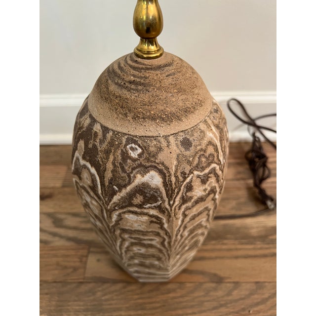 Beautiful swirls of sand and soil. Stamped at the bottom.