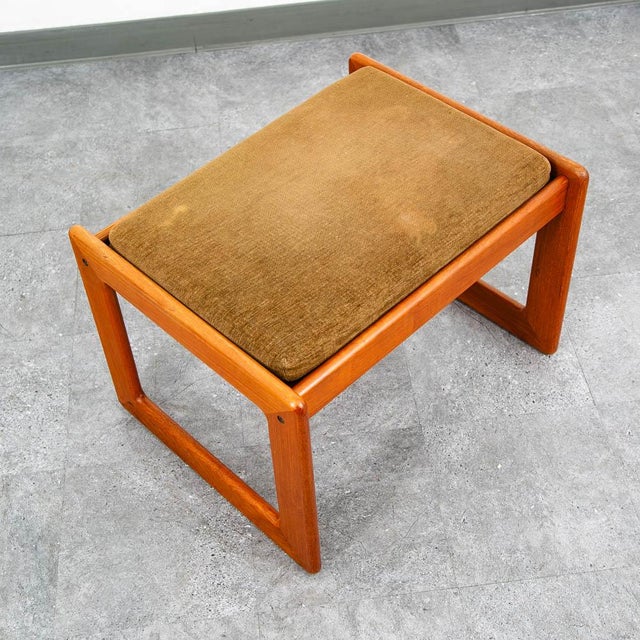 Komfort Ottoman / footstool in a rectangular shape with a brown fabric cushion.
