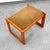 Komfort Ottoman / footstool in a rectangular shape with a brown fabric cushion.