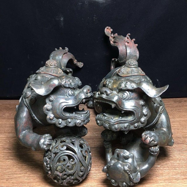 This impressive pair of large bronze guardian lion incense burners makes a commanding statement. Each lion is finely cast...