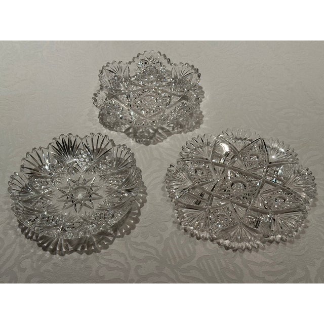 These three plates are extensively hand cut 50% lead crystal. The intense faceting of the crystal excused jewel-like...