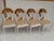 Set of four Hollywood Regency chairs with carved and gold leaf lotus flowers and newly upholstered in soft textured...