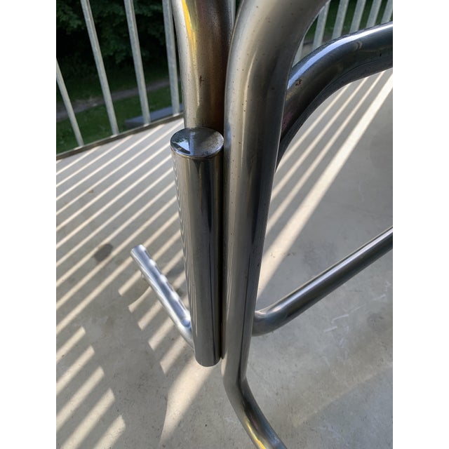 The table frame is an original from the 1920s. The round table legs at the top and bottom are adjustable for stability....
