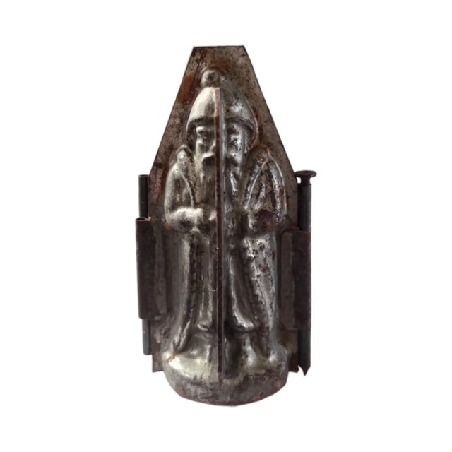 A set of 4 antique French metal chocolate molds of Santa Claus or le Pere Noel, smallest 3.5", largest 6", some missing...