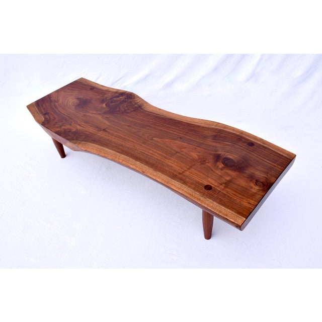 Noteworthy 1950's hand-crafted 4" thick studio made table of solid black walnut with mortise and tenon joinery. Consistent...