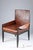A refined custom chair in the style of Jean-Michel Frank, upholstered in cognac vegan leather on a clean dark steel frame....