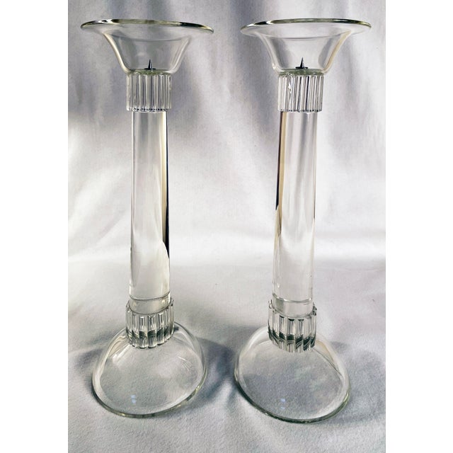 A dramatic pair of monumental hand-crafted clear glass candlesticks, distinguished by their extraordinary scale,...