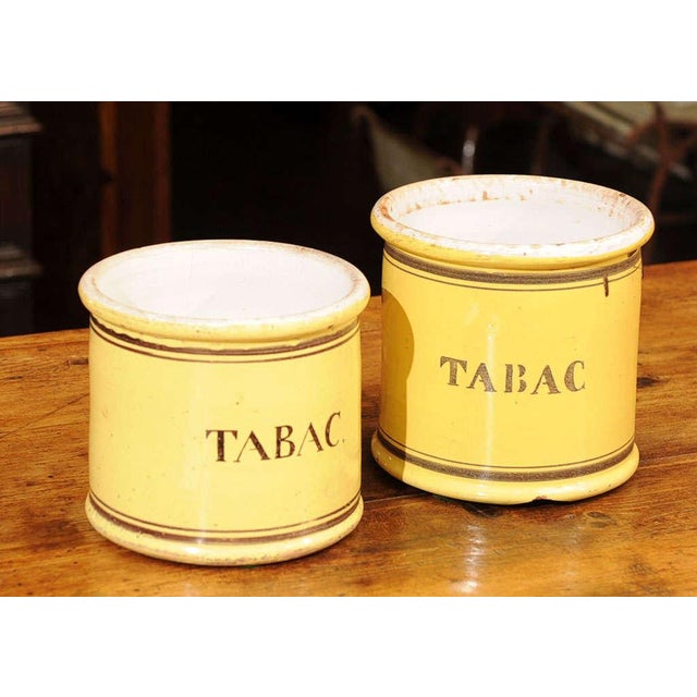 Pair of yellow glazed ceramic "Tabac" jars; French, circa 1880.
