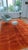 A warm terracotta-orange Moroccan rug with a hand-carved relief that breaks the deep pile into soft brick-like panels....