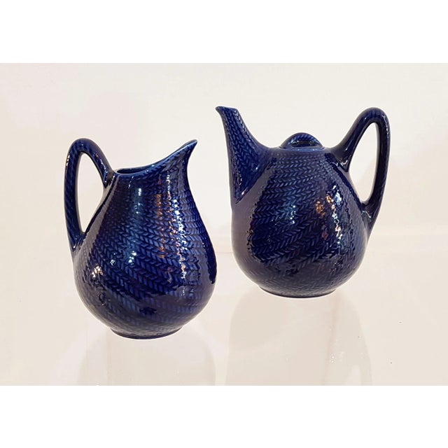 Striking teapot and milk jug from the series 'blå eld' translated to 'blue fire' in english. In quality earthenware from...