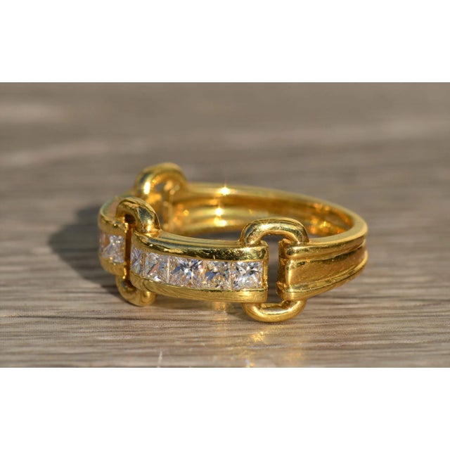 The Evania Ladies 18K Diamond Buckle Style Ring. Crafted in bright 18 karat yellow gold, this ladies ring features 1 carat...