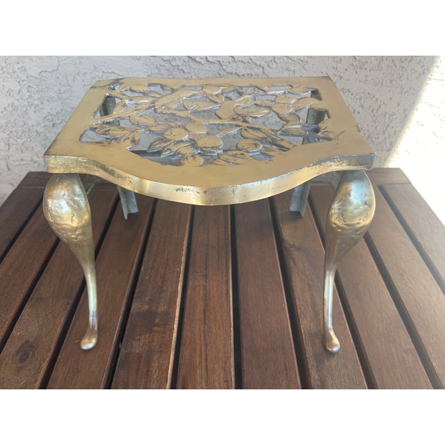 Vintage Home is pleased to present this 1800s Antique Kettle Stand. The English cast brass stand features two birds...