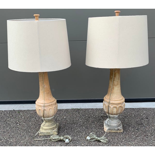 A striking pair of late 20th century French plaster table lamps featuring tall sculptural column forms in a beautiful sun-...