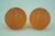 A delightful pair of tennis ball-shaped paperweights made of orange sandblasted glass, with added selenium and colloidal...