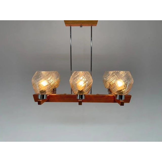 Wooden chandelier made in the 1970's by Elektroinstala Decín (labeled). Good vintage condition. Bulbs: 6 x E25-E27. This...