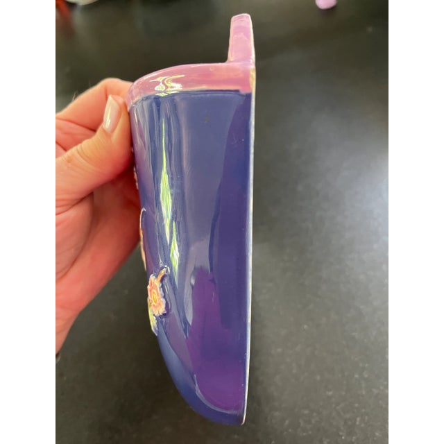 Add some color to your interior with this vintage majolica wall planter. It is a beautiful cobalt blue adorned with a bird...