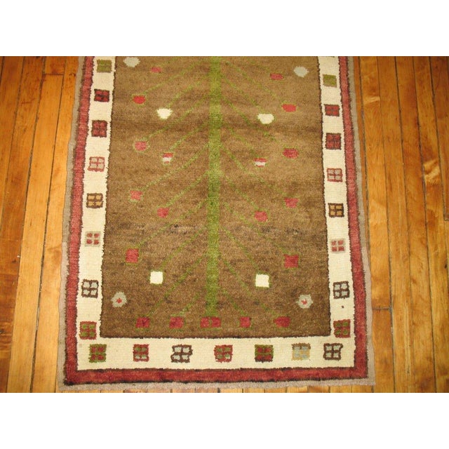 A fascinating small Turkish rug featuring a planted flower tree surrounded by a thin ivory border with small square-shaped...