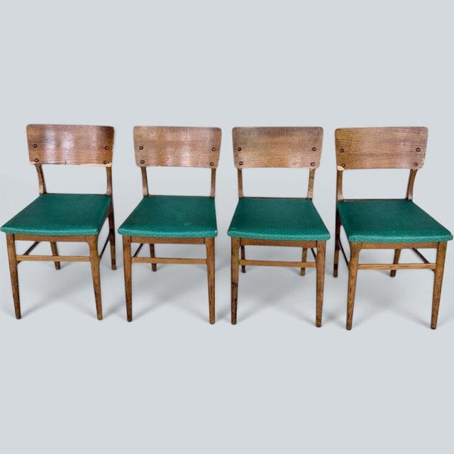 Mid Century Oak Dining Chairs – Set of Four | British Vintage Dining Chairs with Green Vinyl Seats | 1960s A charming set...