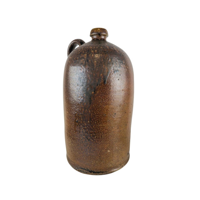Hard-fired stoneware water bottle (Wasserflasche), Crinitz, Lusatia, circa 1900. Tall cylindrical body with a rounded...