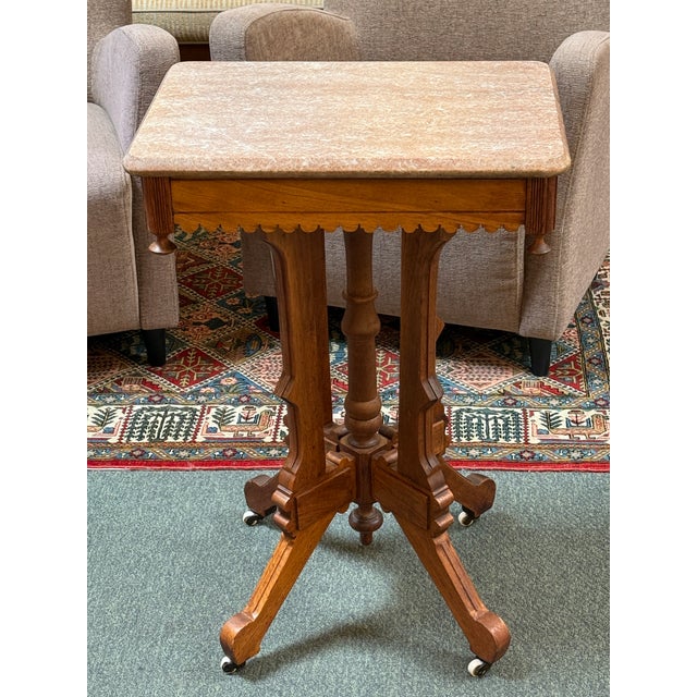 Design Plus Gallery presents a Walnut Wood Parlor Table from the Victorian Eastlake Era of the Late 19th Century. The...