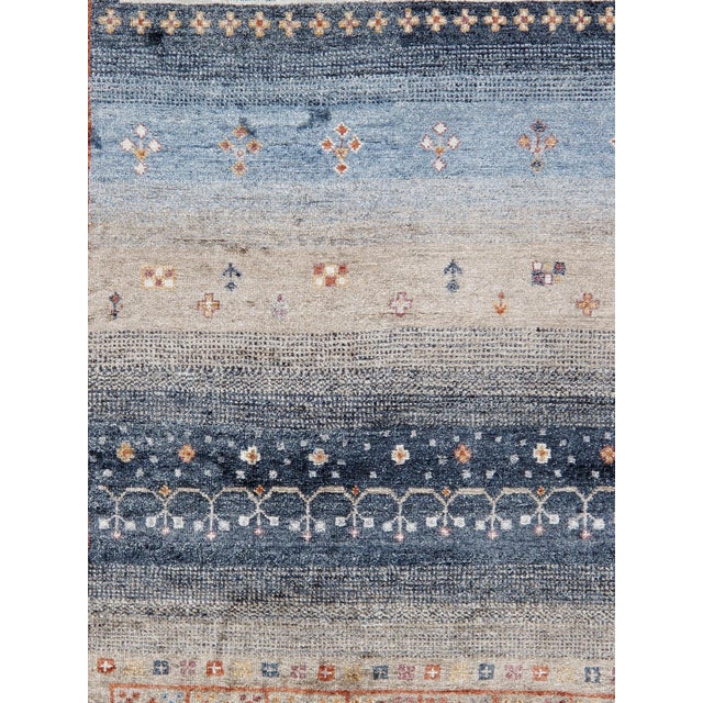 Tribal Hand-Knotted Area Rug is handmade with extra high pile and very simple, stylized designs. They are constructed from...