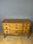 A Louis XV-Louis XVI style transitional commode in cherry wood. It rests on four cabriole legs and features five drawers...