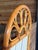 Charming vintage coastal rattan wall mirror featuring an elegant fan-back arch and integrated woven rattan display shelf....