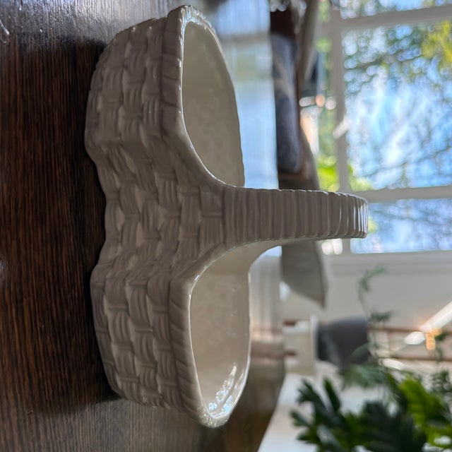 Charming vintage white ceramic serving basket featuring a dimensional woven basket-weave design and tall sculptural...