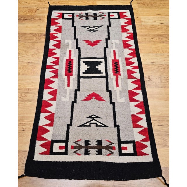 Discover the beauty and craftsmanship of this authentic vintage Navajo style rug, handwoven in the Southwestern United...