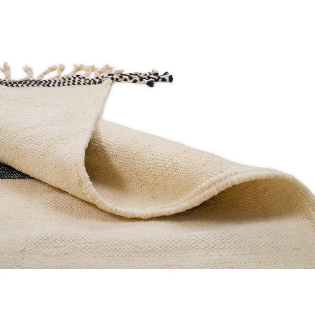 Artistic flatweave rug showcasing abstract shapes in Charcoal, Mustard Yellow, and Sage Green Grey against an Ivory...