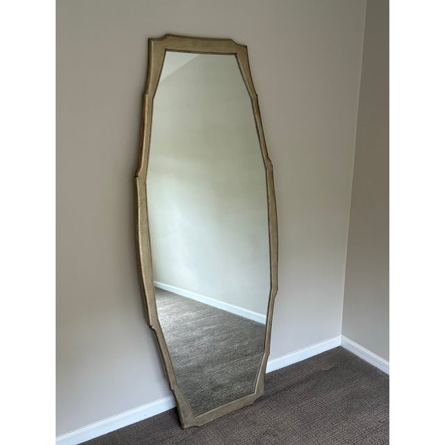 Elegant oversized wall mirror by Baker Furniture featuring a sophisticated elongated octagonal silhouette with a softly...