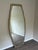 Elegant oversized wall mirror by Baker Furniture featuring a sophisticated elongated octagonal silhouette with a softly...