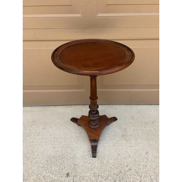 A handsome Regency-style drinks table crafted in rich solid walnut. The elegant turned pedestal and tripod base with brass...