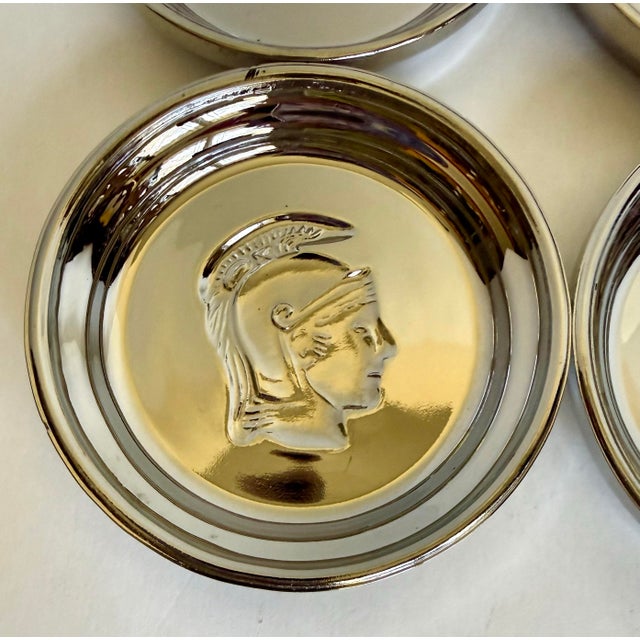 Here is a set of four vintage mercury glass coasters featuring recessed classical warrior profiles. Each round coaster is...