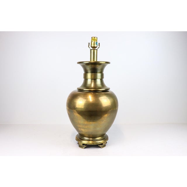 This substantial vintage brass lamp features graceful curves and a weighty presence, making it a beautiful statement on a...