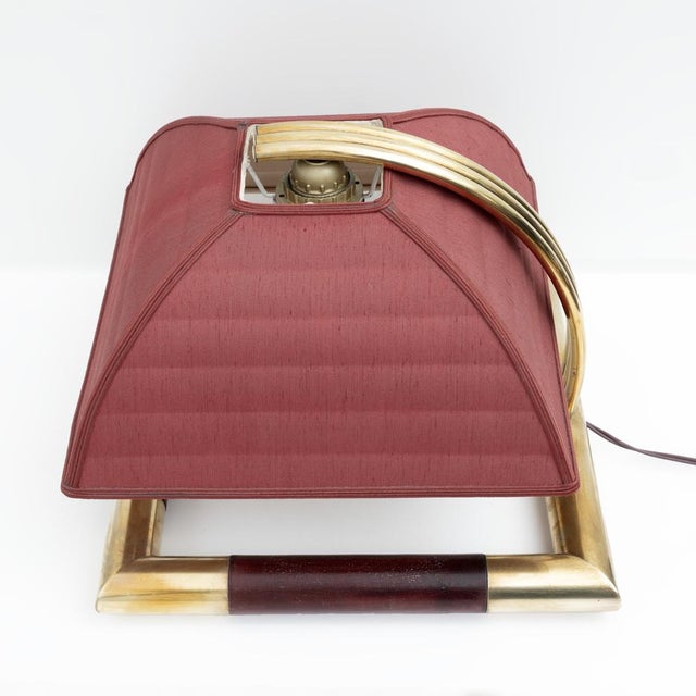 Table lamp in brass and mahogany stained wood, in Tommaso Barbi style, a very particular design lamp of excellent...