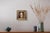 This artwork depicts a woman in a moment of introspection, her features softly illuminated by warm tones that evoke a...