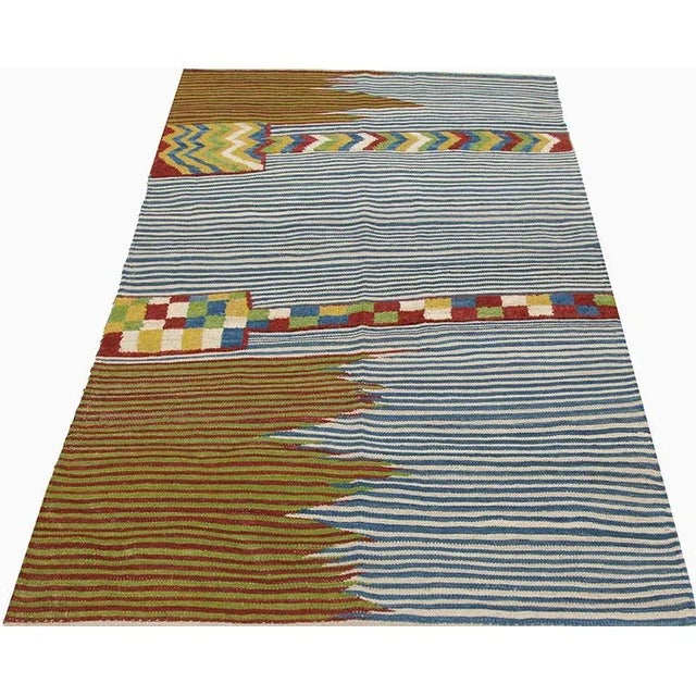 This bewitchingly beautiful example of a tribal Kilim area rug features a contemporary pop of electrifying bright colors...