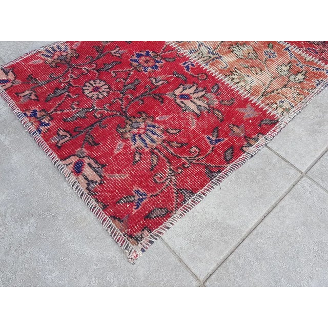 This is a vintage Turkish Oushak rug from the Mid 20th Century. The piece was hand-knotted.