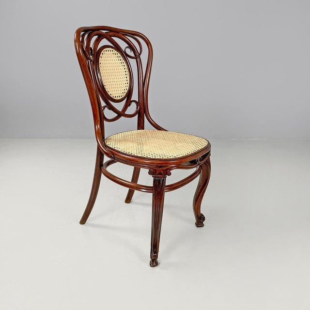 Italian antique wood and Vienna straw chairs with curl details, early 1900s Set of four chairs in wood and Vienna straw....