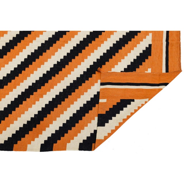 Add a bold, architectural statement to your space with this striking Modern Navajo Style wool rug. Featuring a dynamic...