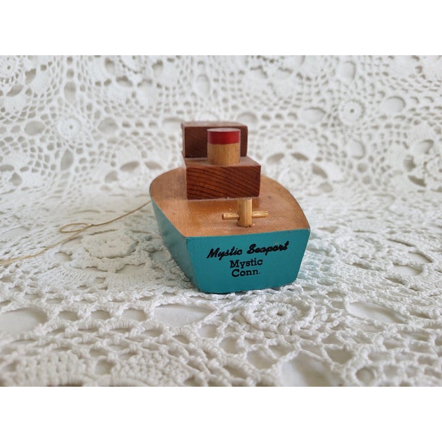 A wooden boat from Mystic Seaport in Mystic, Connecticut. It measures 7” x 3” x 2 ½” h. Wouldn't this look lovely on a...