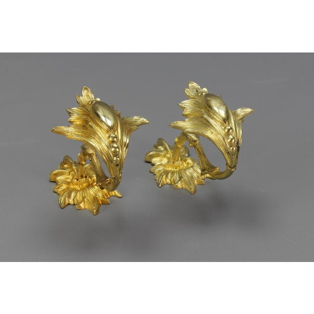 A pair of French Rococo-style bronze curtain tiebacks or curtain holders, from the early 1900s. A beautiful pair of Rococo...