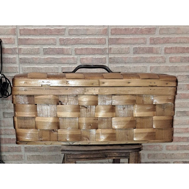 Handwoven wooden box, crafted by traditionally interlacing strips of chestnut wood. This type of basketry is distinguished...
