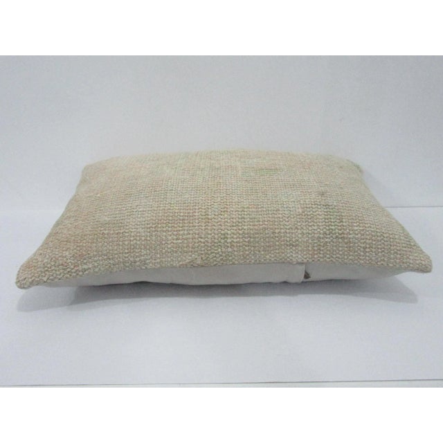 Decorative pillow cover made from a vintage Turkish handknotted rug. Backed with good quality cotton fabric. Pillow...
