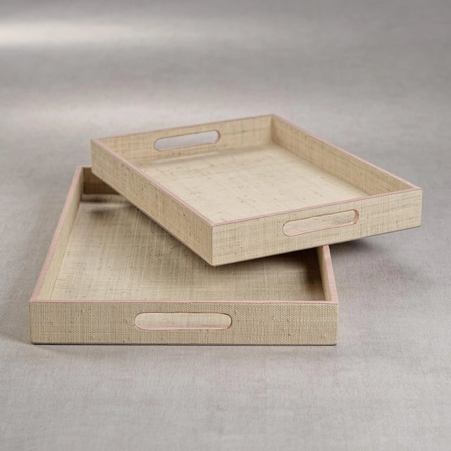 Artisan crafted of wood and then covered with natural raffia fiber, with cow leather trim piping and open cut side handles...